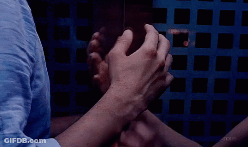 A Group Of People Putting Their Hands Together In A Circle GIF