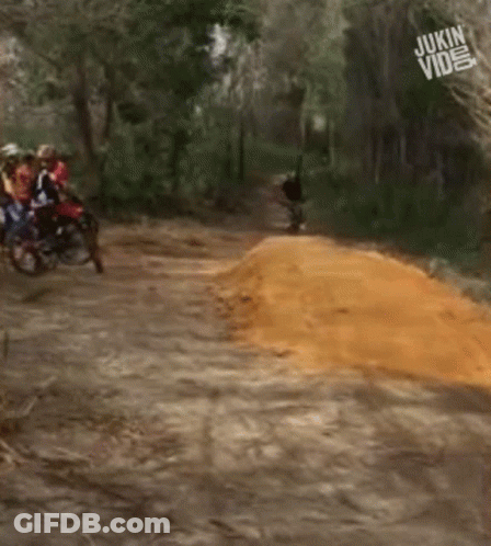 A Group Of People Riding Motorcycles Down A Dirt Road With The Words Jukin Video In The Corner GIF