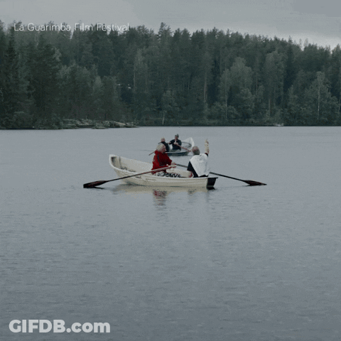 A Group Of People Rowing A Boat In A Lake With La Guarimba Film Festival Written On The Bottom Of The Image GIF