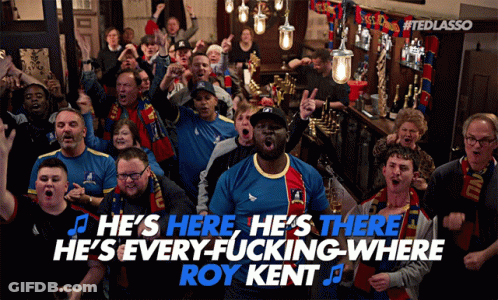 A Group Of People Singing He 'S Here He 'S There He 'S Everywhere Where Roy Kent GIF