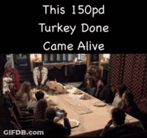 A Group Of People Sitting Around A Table With A Sign That Says This 150Pd Turkey Done Came Alive GIF