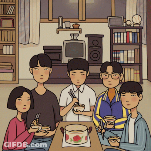 A Group Of People Sitting Around A Table With Bowls Of Food GIF