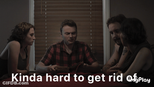 A Group Of People Sitting Around A Table With Something You Can 'T See Play Written In White Letters GIF