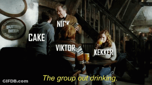 A Group Of People Sitting Around A Table With The Words " The Group Out Drinking " GIF