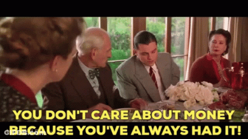 A Group Of People Sitting Around A Table With The Words You Don 'T Care About Money GIF