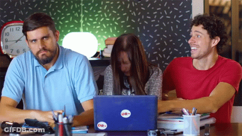 A Group Of People Sitting At A Table With A Laptop That Says Or On It GIF