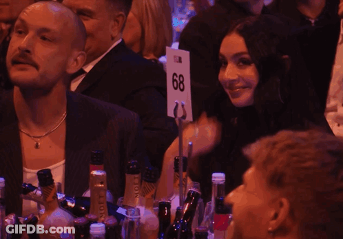 A Group Of People Sitting At A Table With Bottles Of Moet Champagne GIF