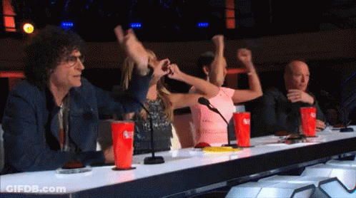 A Group Of People Sitting At A Table With Coca Cola Cups On It GIF