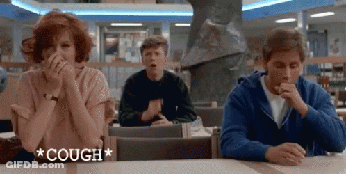 A Group Of People Sitting At A Table With The Word Cough Written On It GIF