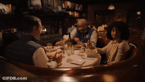 A Group Of People Sitting At A Table With The Words I 'M Jokin ' Written On The Bottom GIF