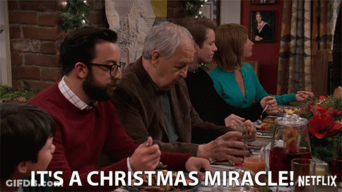 A Group Of People Sitting At A Table With The Words It 'S A Christmas Miracle Netflix On The Bottom GIF