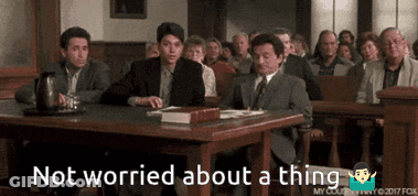 A Group Of People Sitting At A Table With The Words " Not Worried About A Thing " On The Bottom GIF