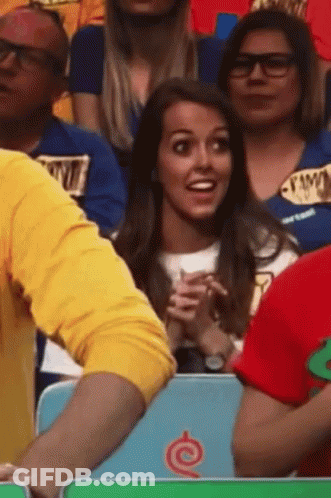 A Group Of People Sitting In A Stadium With One Wearing A Shirt That Says ' I Love You ' GIF