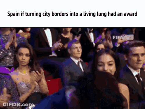 A Group Of People Sitting In A Stadium With The Caption Spain If Turning City Borders Into A Living Lung Had An Award . GIF