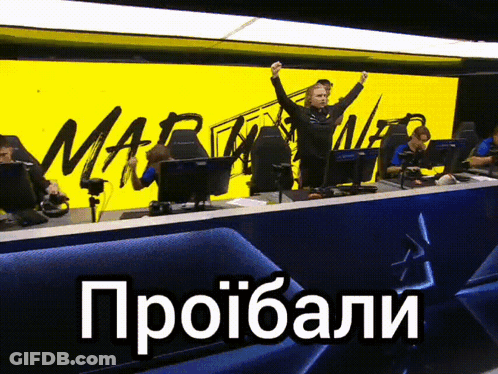 A Group Of People Sitting In Front Of A Yellow Sign That Says Mar GIF