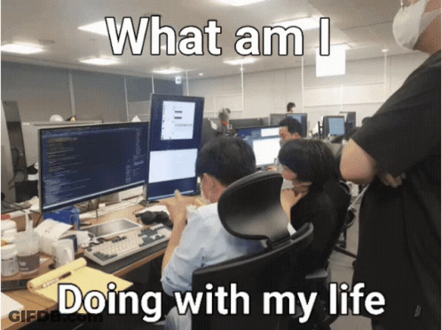 A Group Of People Sitting In Front Of Computer Monitors With The Words What Am I Doing With My Life Below Them GIF