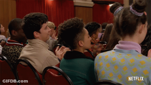 A Group Of People Sitting In Red Chairs With Netflix Written On The Bottom GIF