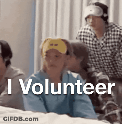 A Group Of People Sitting On A Bed With The Words I Volunteer GIF