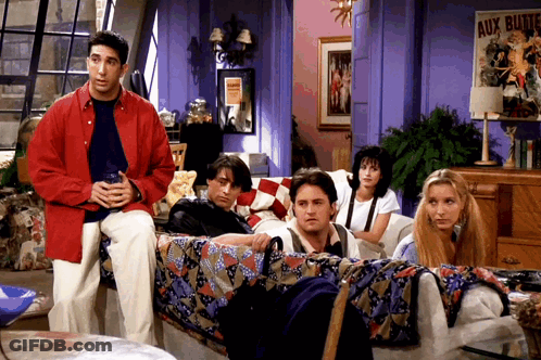 A Group Of People Sitting On A Couch In Front Of A Sign That Says Aux Bluttes GIF