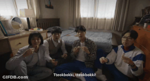 A Group Of People Sitting On The Floor With Tteokbokki Written On The Bottom Right GIF