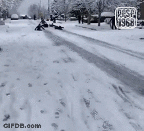 A Group Of People Sledding Down A Snow Covered Street With The Year 1968 On The Bottom GIF