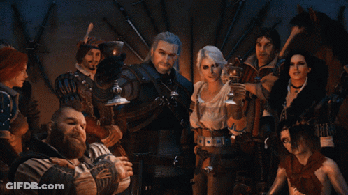 A Group Of People Standing Around A Man Holding A Glass GIF