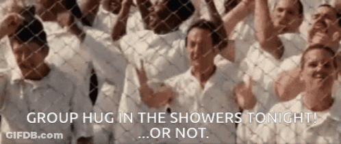 A Group Of People Standing Behind A Chain Link Fence With The Words Group Hug In The Showers Tonight Or Not GIF