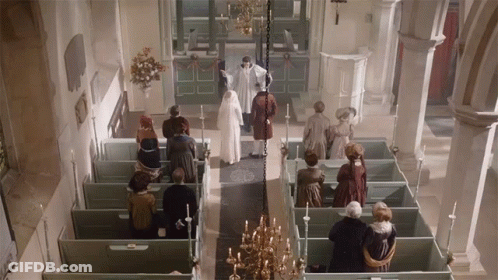 A Group Of People Standing In A Church With A Priest GIF
