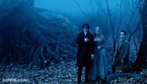 A Group Of People Standing In A Dark Forest With A Blue Sky In The Background GIF