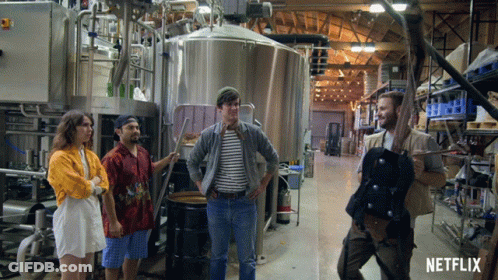 Group Standing In Factory With Netflix Logo GIF