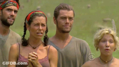 A Group Of People Standing In A Field With One Woman Wearing A Necklace That Says Cbs On It GIF