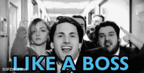 A Group Of People Standing In A Hallway With The Words Like A Boss Written On The Bottom GIF