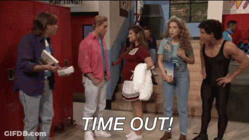 A Group Of People Standing In A Hallway With The Words Time Out Written On The Floor GIF