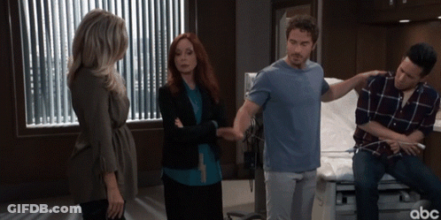 A Group Of People Standing In A Hospital Room With Abc Written On The Bottom Right GIF