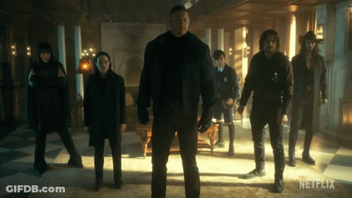 A Group Of People Standing In A Room With A Netflix Logo On The Bottom GIF