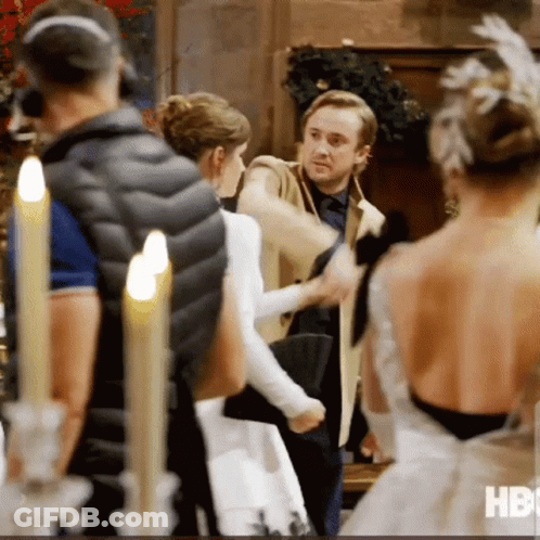 A Group Of People Standing In A Room With Candles And The Word Hbo On The Bottom Right GIF
