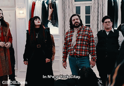 A Group Of People Standing In A Room With The Words In New York Citay On The Bottom GIF
