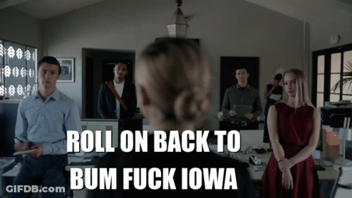 A Group Of People Standing In An Office With The Words Roll On Back To Bum Fuck Iowa On The Bottom GIF