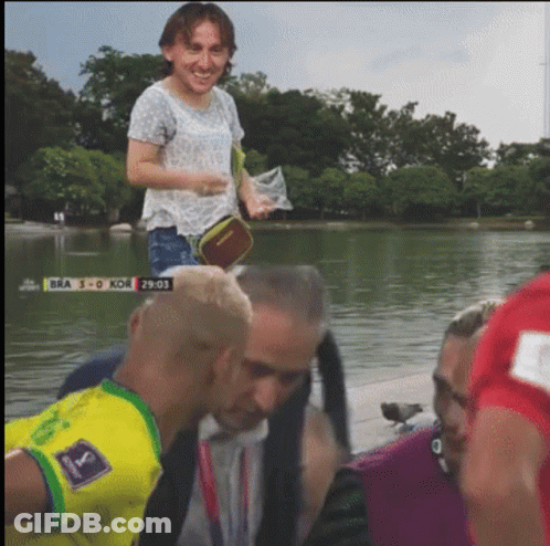 A Group Of People Standing In Front Of A Body Of Water With Bra 3-0 Kor Written On The Screen GIF