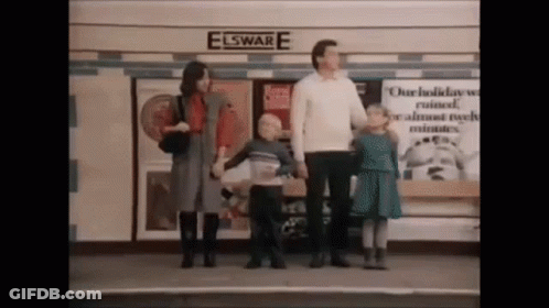 A Group Of People Standing In Front Of A Building That Says Elsware GIF