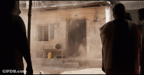 A Group Of People Standing In Front Of A Building With A Sign That Says ' No Smoking ' On It GIF
