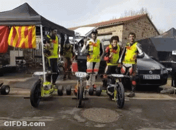 A Group Of People Standing In Front Of A Car With A License Plate That Says Yv7lc Gpd GIF