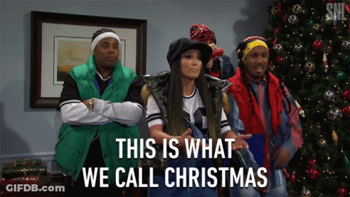 A Group Of People Standing In Front Of A Christmas Tree With The Words This Is What We Call Christmas GIF