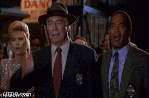 A Group Of People Standing In Front Of A Dang Sign GIF