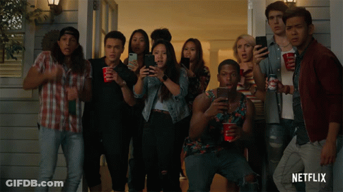 A Group Of People Standing In Front Of A House With Netflix Written On The Bottom Right GIF