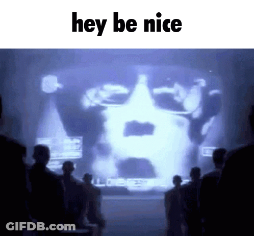 A Group Of People Standing In Front Of A Large Screen That Says Hey Be Nice GIF