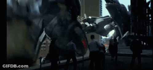 A Group Of People Standing In Front Of A Large Statue GIF