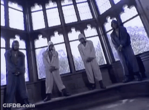 A Group Of People Standing In Front Of A Large Window GIF