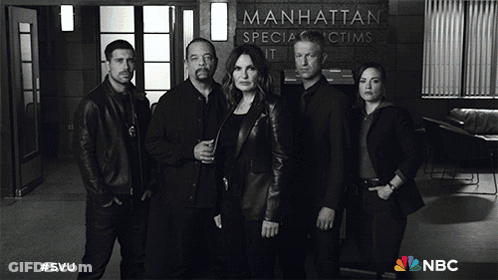 A Group Of People Standing In Front Of A Manhattan Special Victims Unit Sign GIF