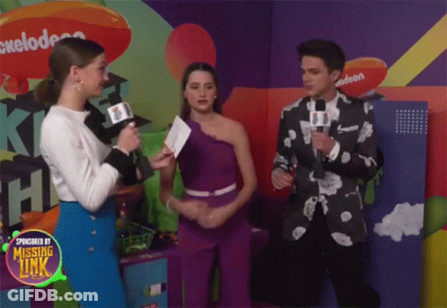 A Group Of People Standing In Front Of A Nickelodeon Logo GIF